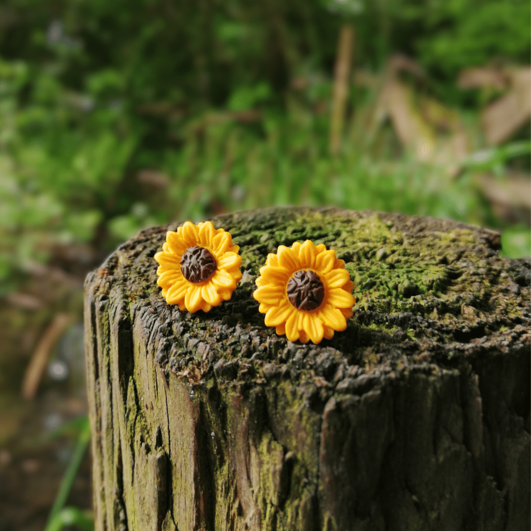 Intricate hand crafted polymer clay Sunflower studs with nature background, made in Dorset.