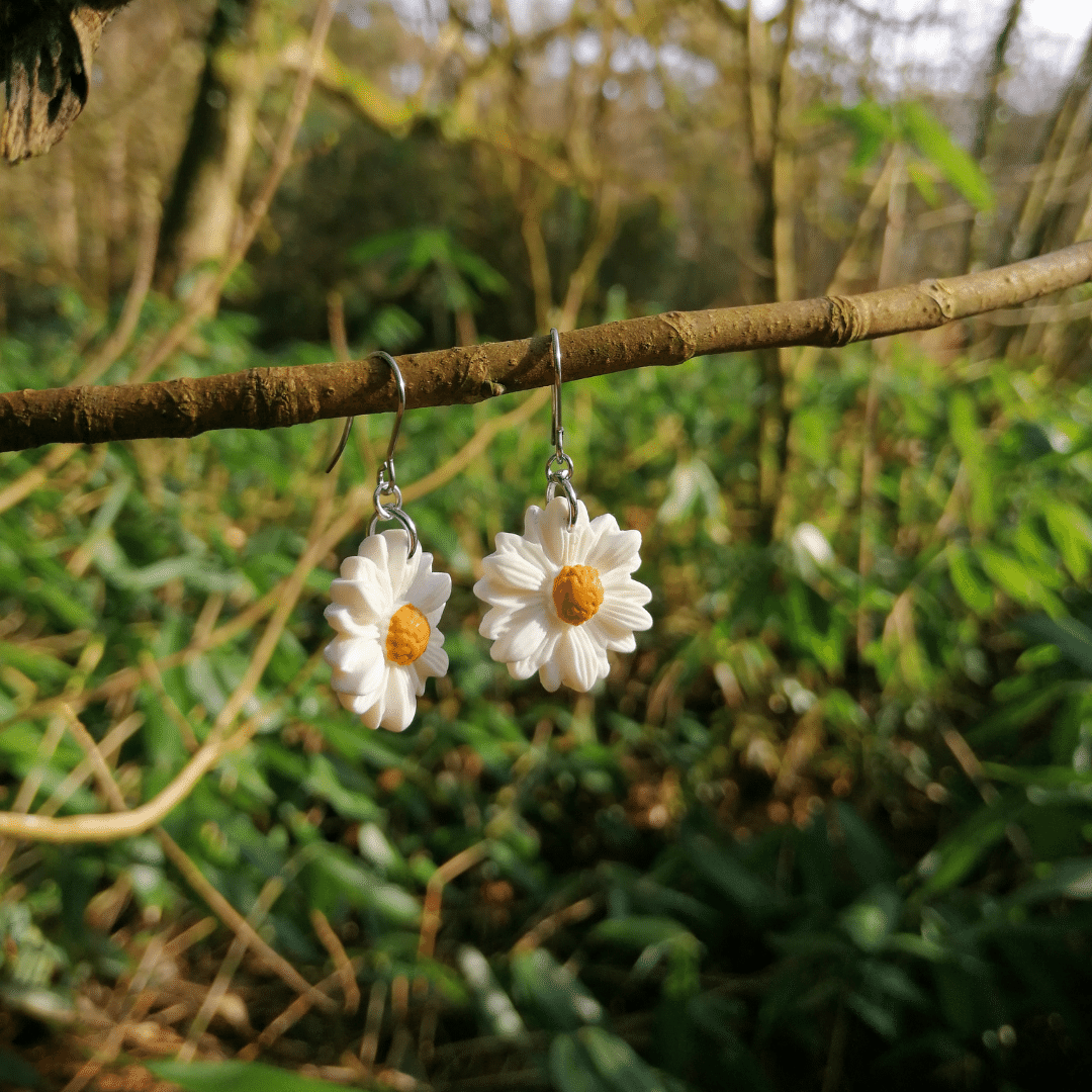 Side View image of our Intricate Minimalistic Everyday Daisy Hook Earrings with Nature Background.
