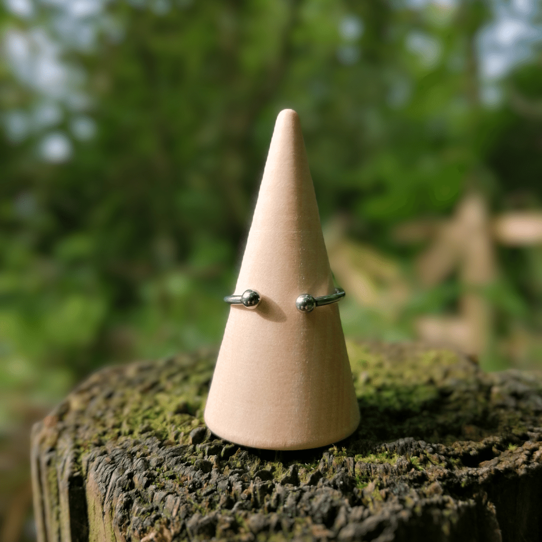 Back of our Intricate Adjustable Polymer Clay Daisy Ring with Nature Background.