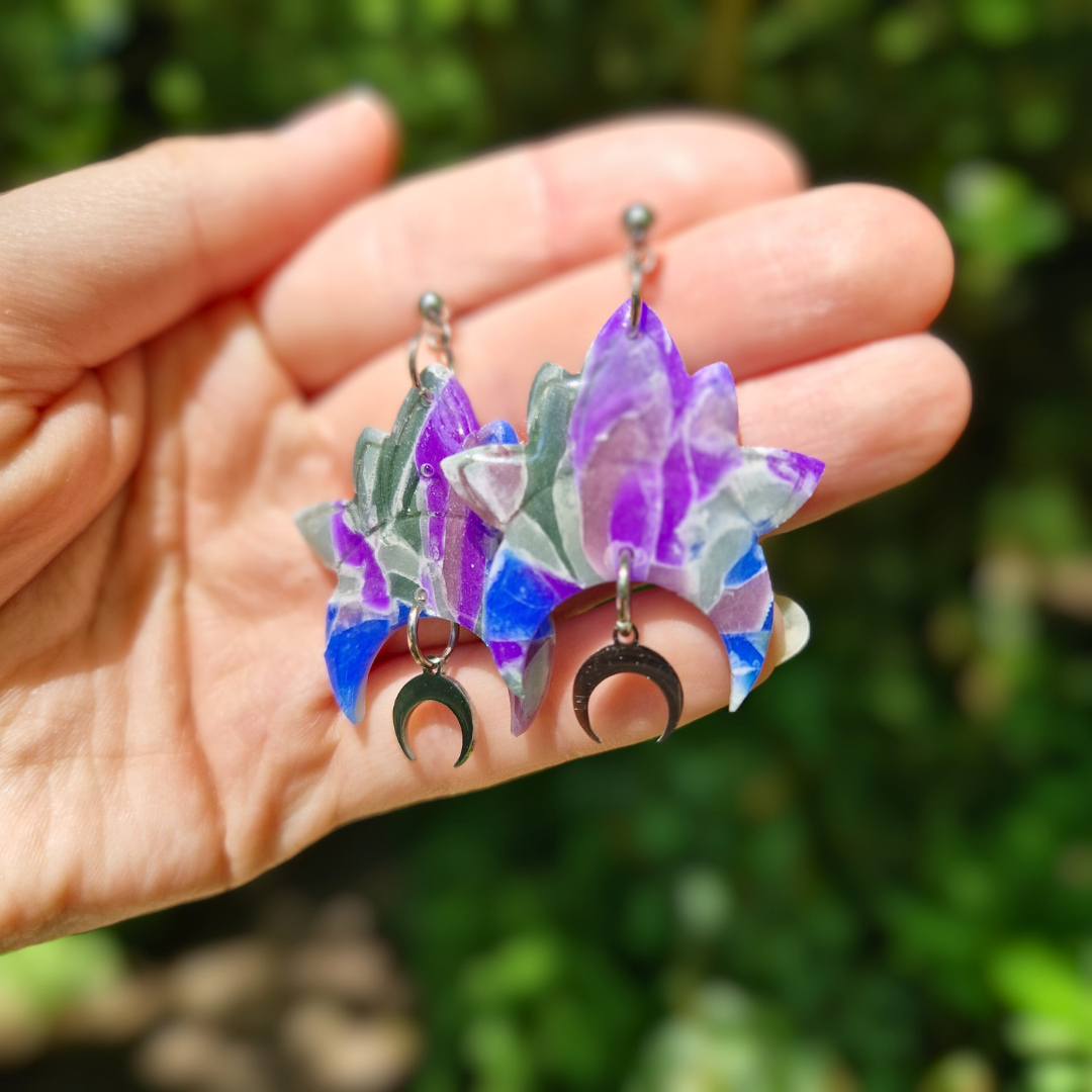 Hand for Scale Image of the Translucent Celestial Drop Studs with Moon Charm with Nature Background