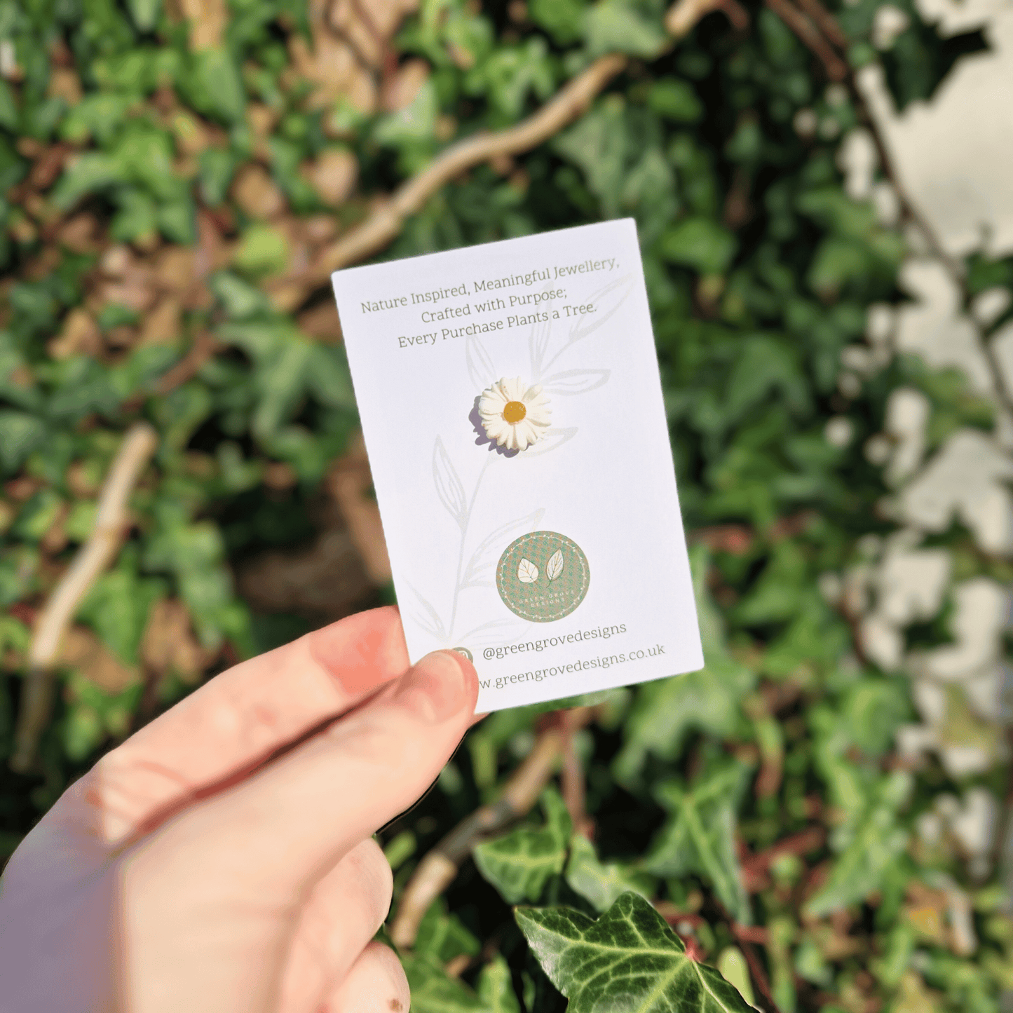 Tiny Intricate Polymer Clay Daisy Pin Hand Crafted in Dorset in Hand for Scale.
