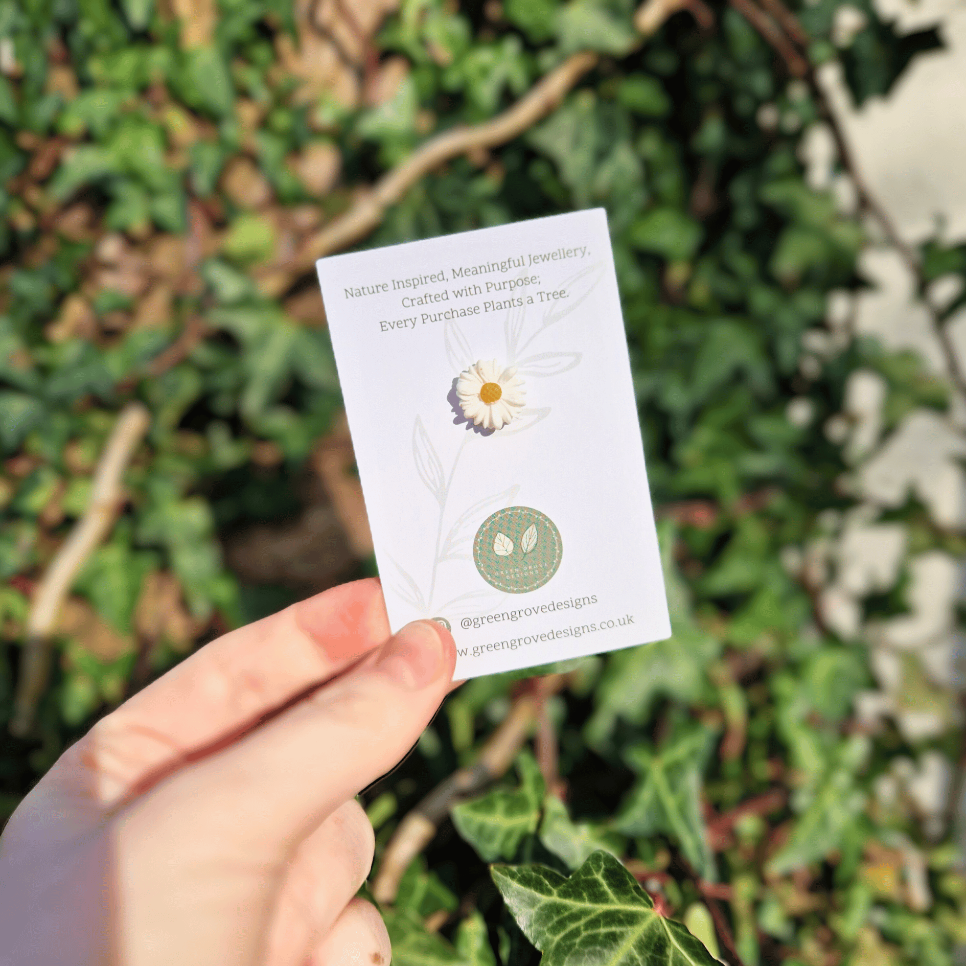 Tiny Intricate Polymer Clay Daisy Pin Hand Crafted in Dorset in Hand for Scale.