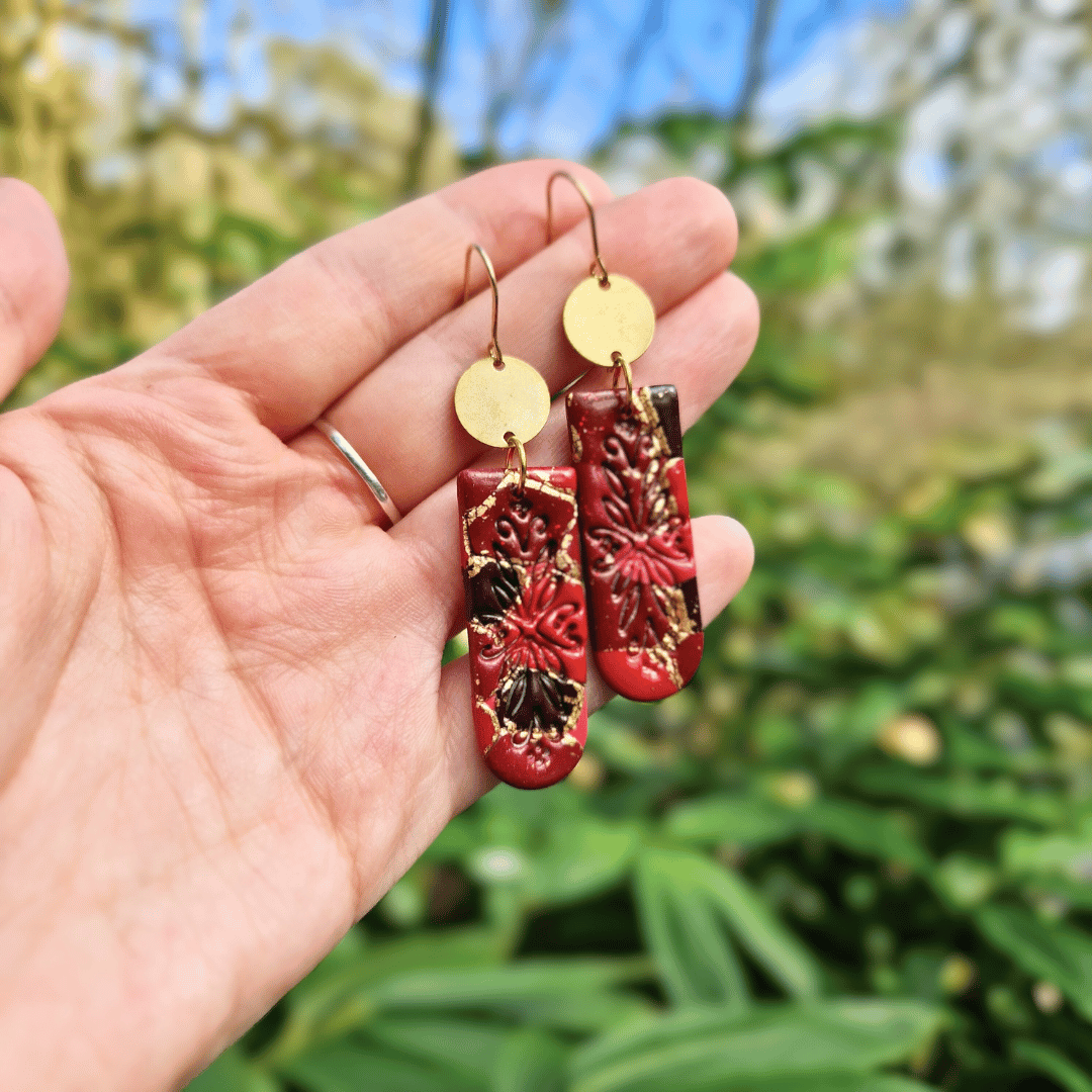Hand for Scale Image of the Floral Embossed Zero Waste Hook Earrings.