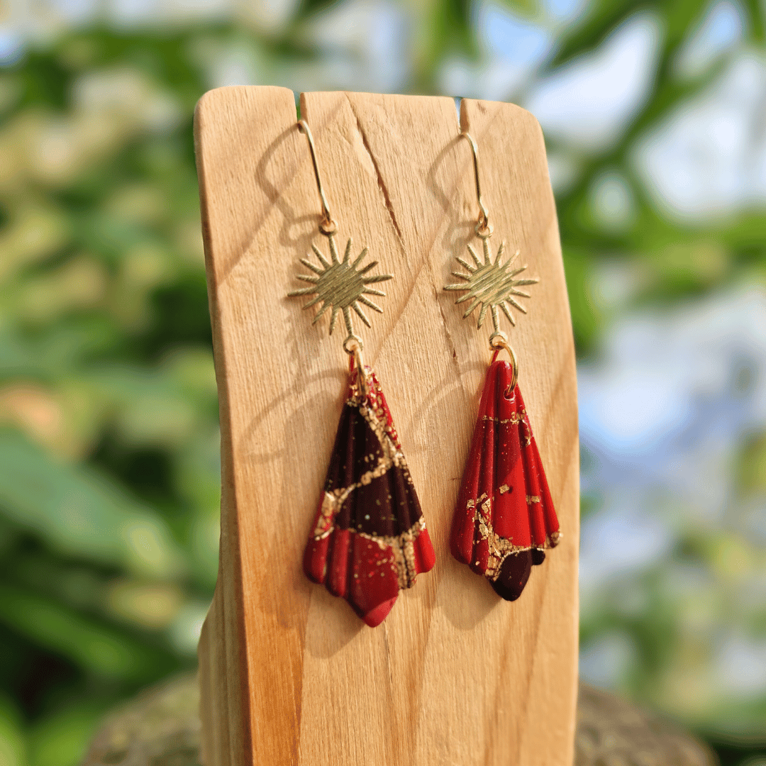 Close up Image of the Zero Waste Reds and Gold Sun Charm Hook Earrings.