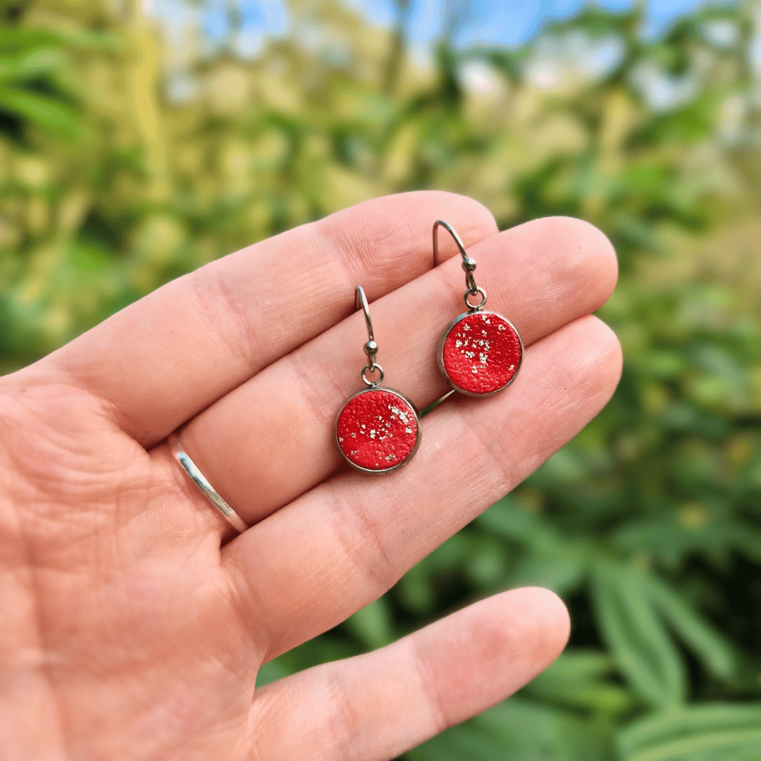 Hand for Scale Image for Option 1 of the Everyday Reds and Silver Tray Earrings with Nature Background.