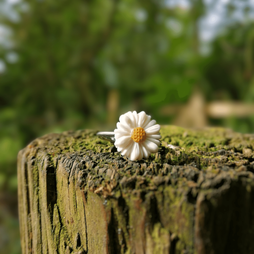 Close up of our Intricate Polymer Clay Daisy Ring on Wooden Post.