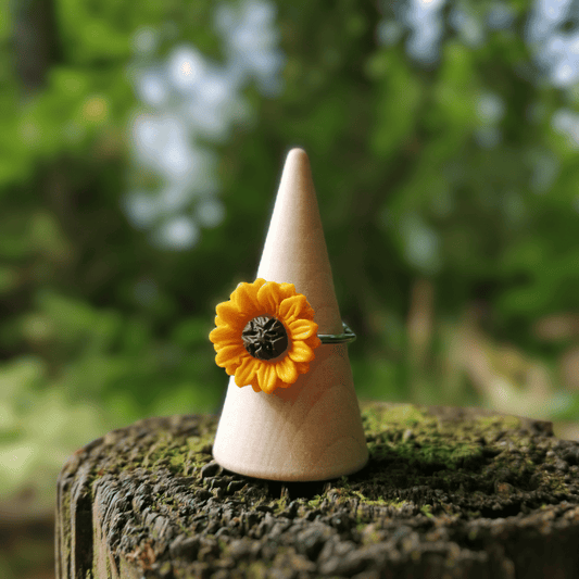 Joyful polymer clay Sunflower Adjustable Ring on wooden stand with nature background thumbnail.