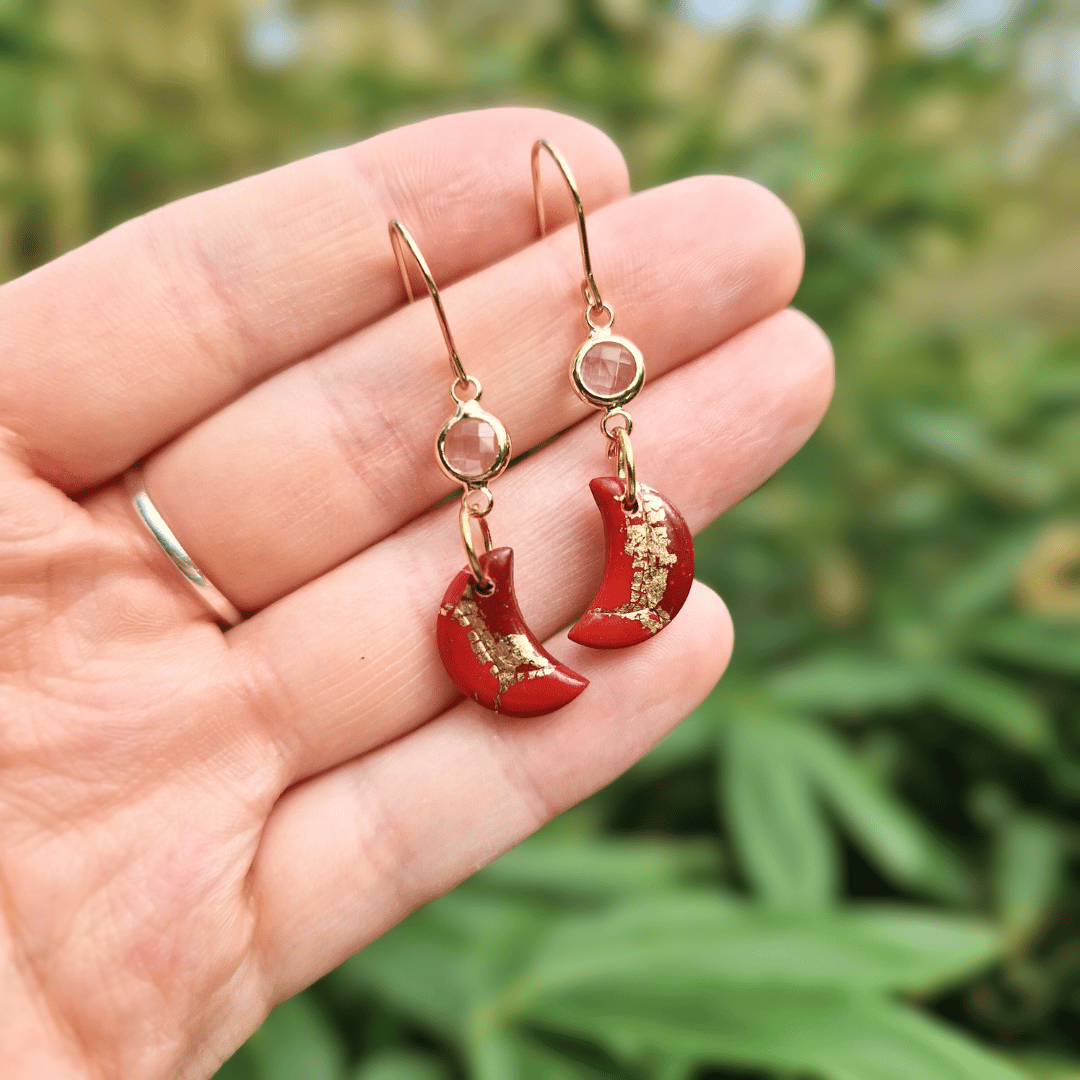 Hand for Scale Image for Option 2 of the Zero Waste Reds and Gold Crescent Moon and Glass Earrings.