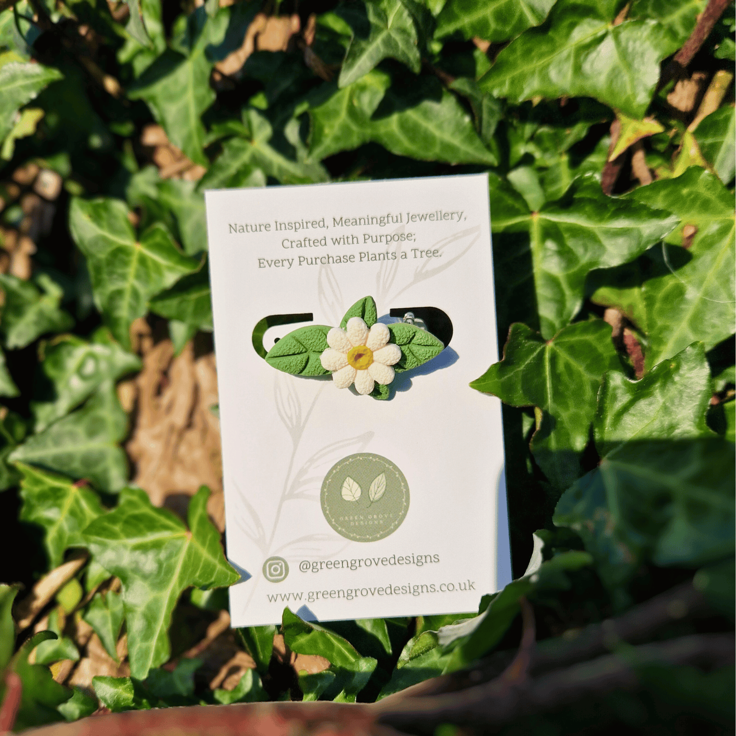 Polymer Clay Daisy and Leaf Brooch Hand Crafted in Dorset with Nature Background.