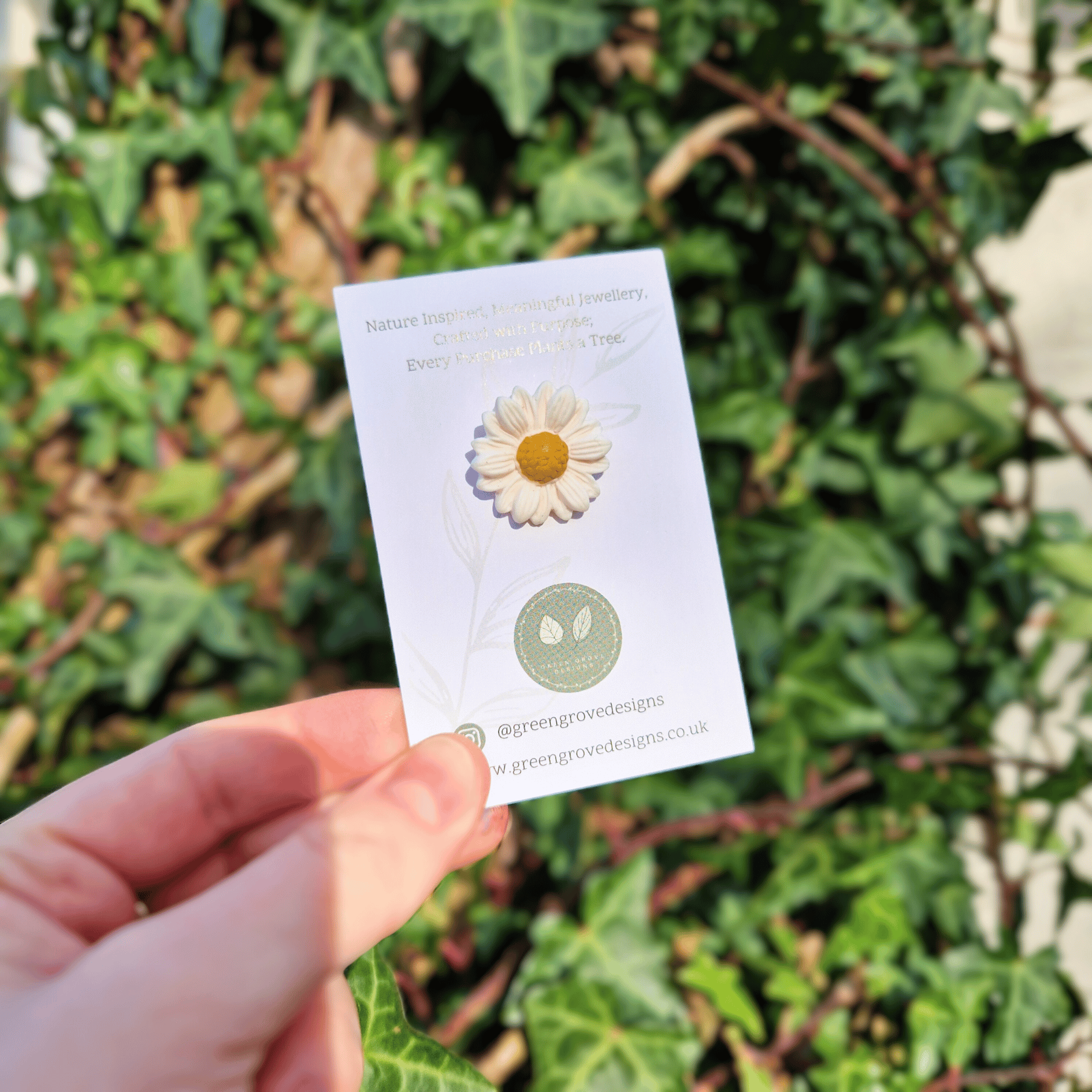 Intricate Larger Polymer Clay Daisy Nature Pin with Hand for Scale.