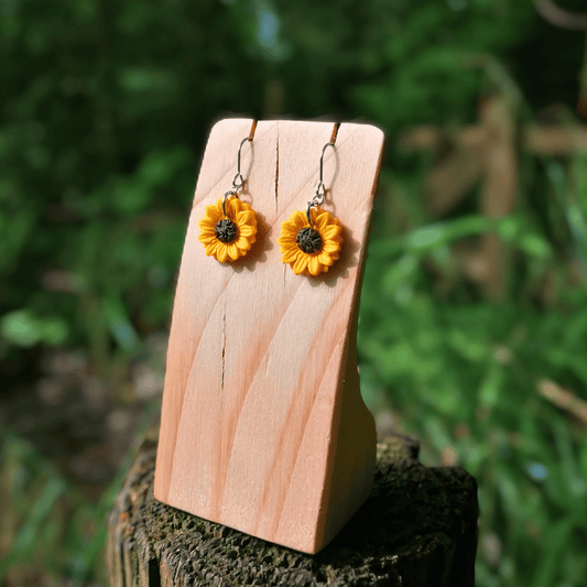 Joyful polymer clay Sunflower hook earrings on wooden stand thumbnail.