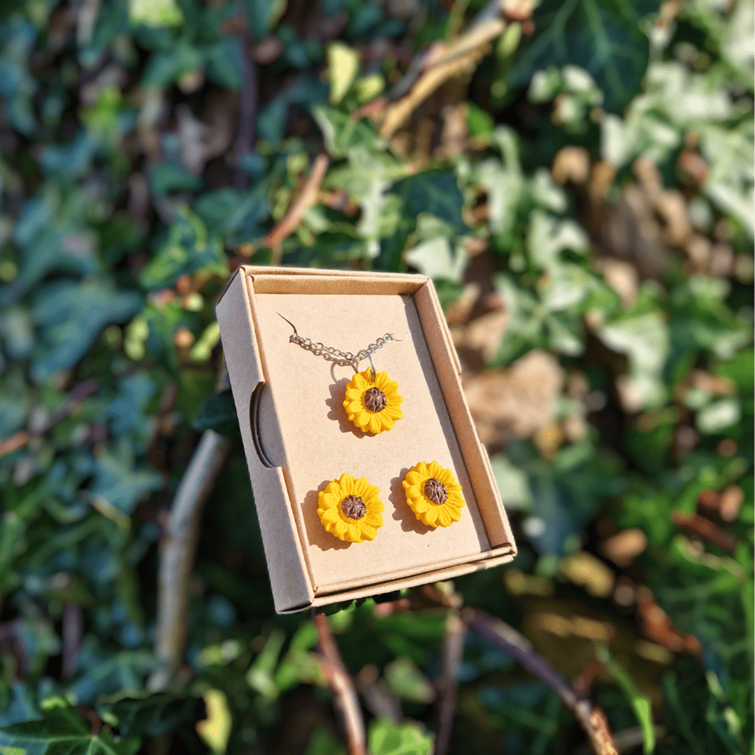 Hand crafted polymer clay Sunflower necklace and stud set with nature background.