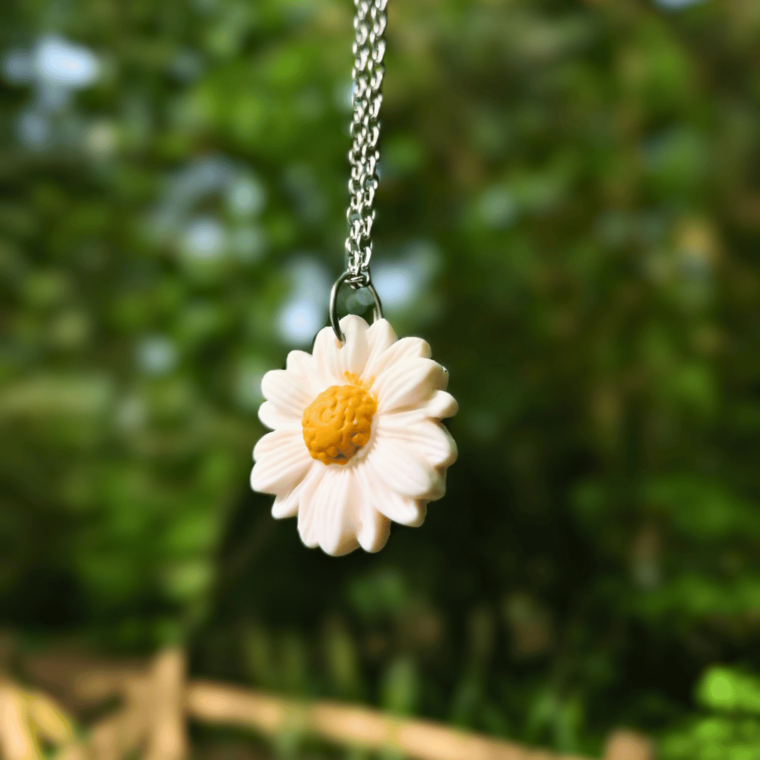 Close up Image of our Polymer Clay Intricate Daisy Necklace with Nature Background.