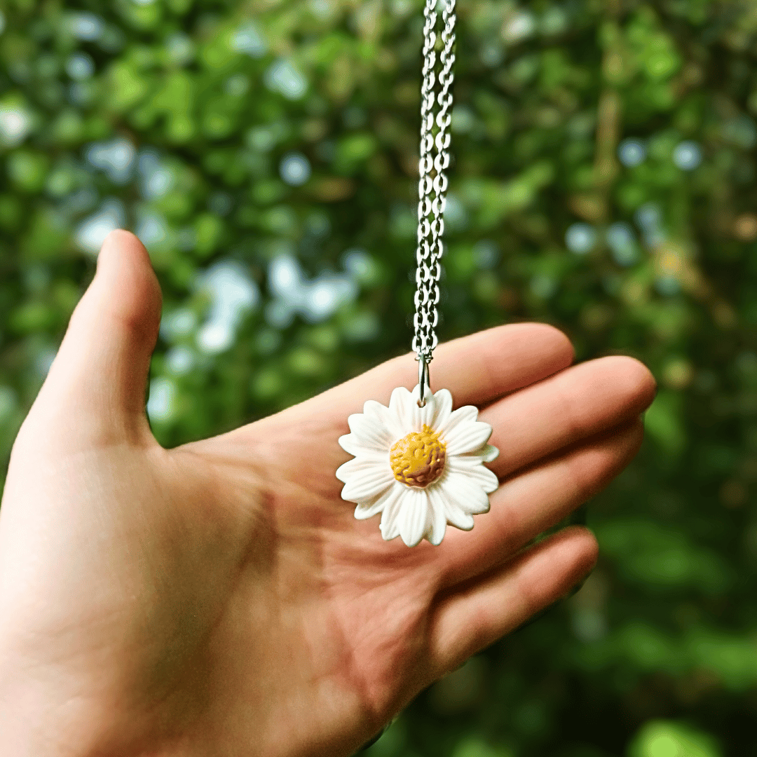 Intricate Polymer Clay Daisy Necklace with Hand for Scale, Hand Crafted in Dorset.