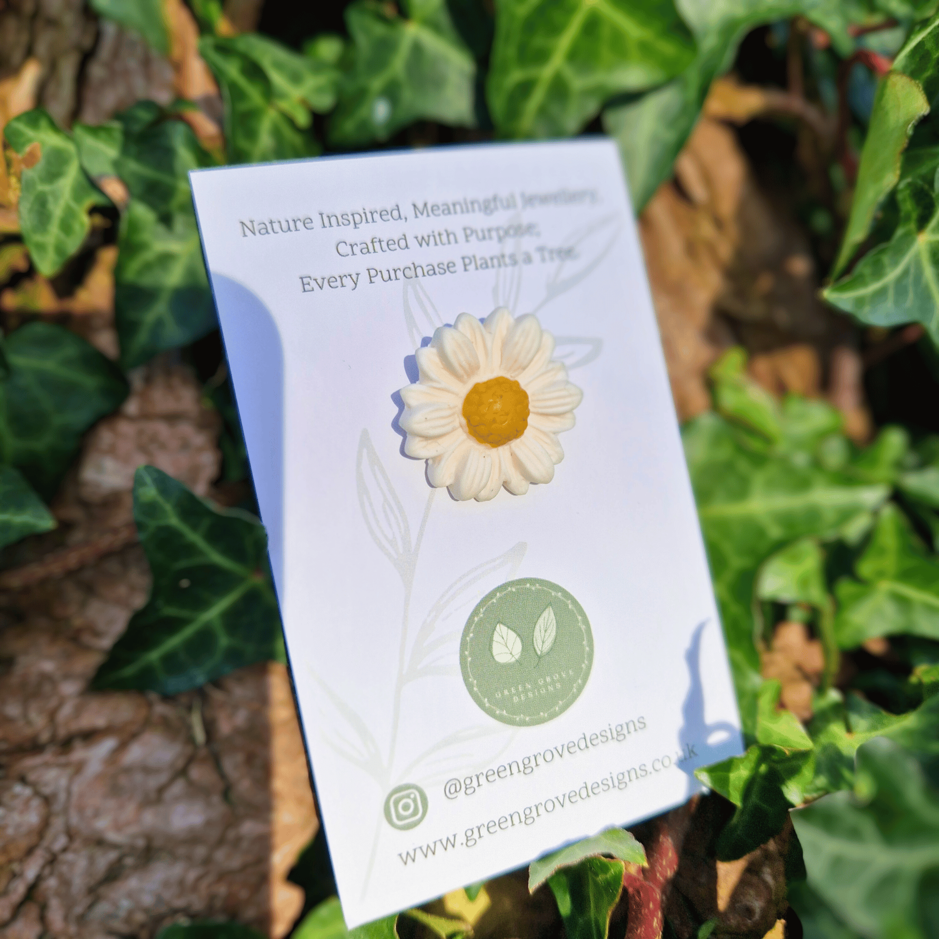 Close up Image of our Intricate and Detailed Larger Daisy Pin with Ivy Background.